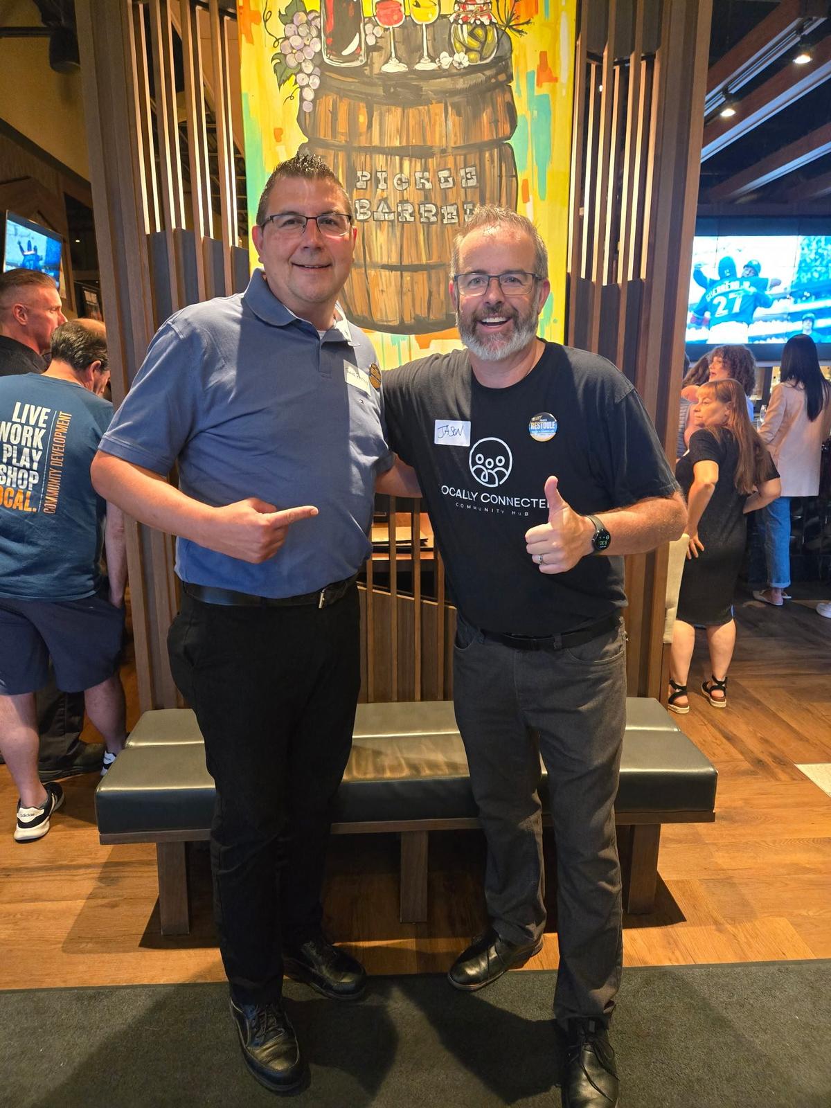 Travis Restoule with a community member at a local community event in Waterloo